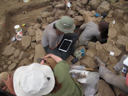Students using the iPads for in-field data collection in one of the tomb contexts